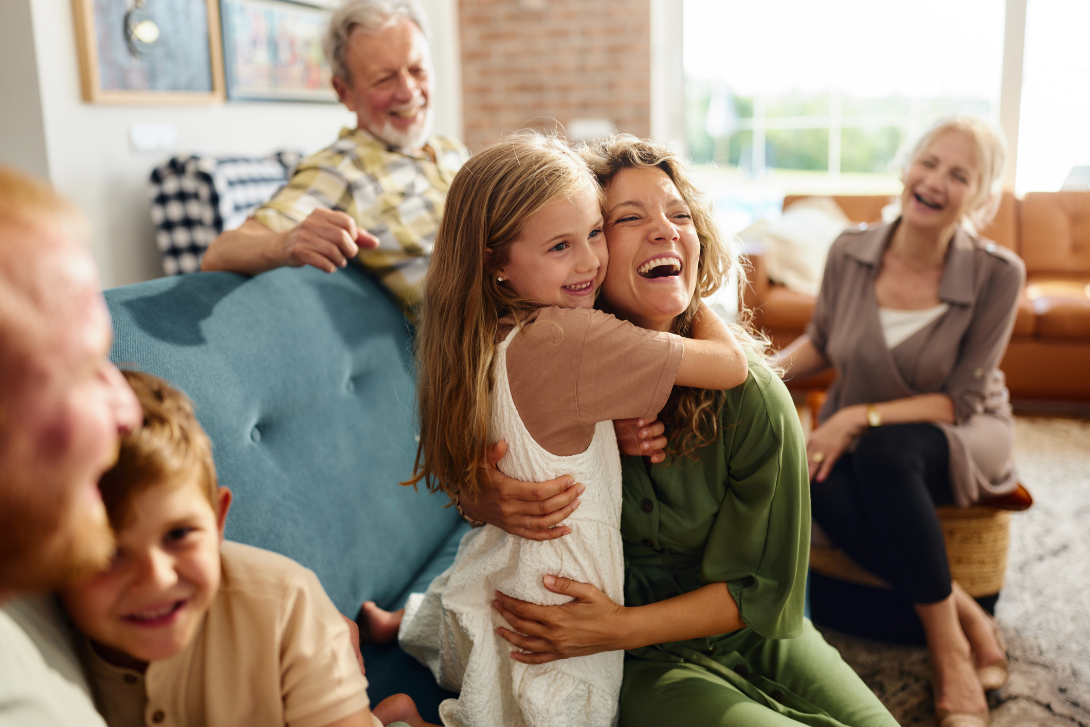 Multigenerational family laughing together at home
